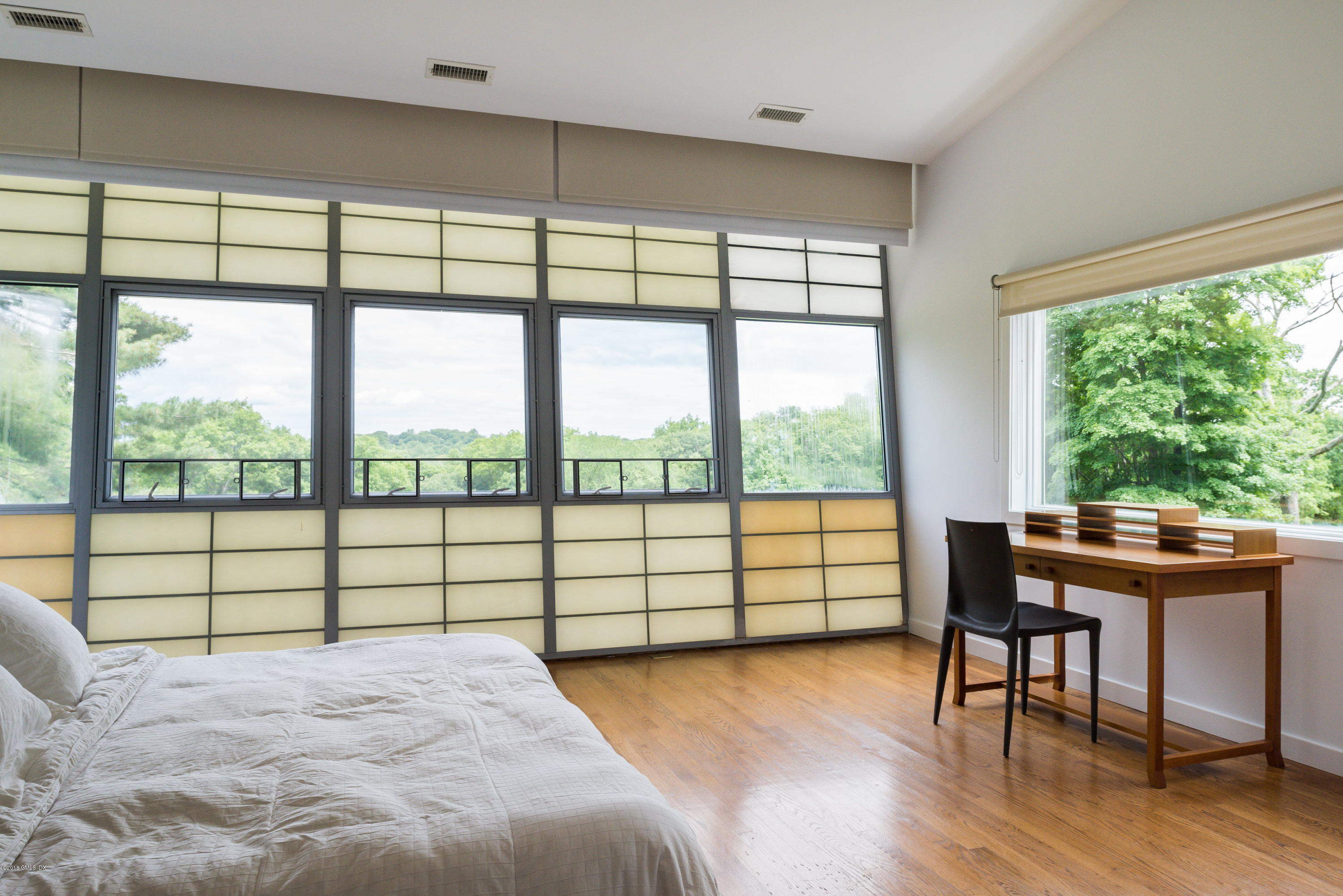 491 Riversville Road Greenwich, CT 06831 - Photo 23 of 30 a view of a bedroom with a large window and table