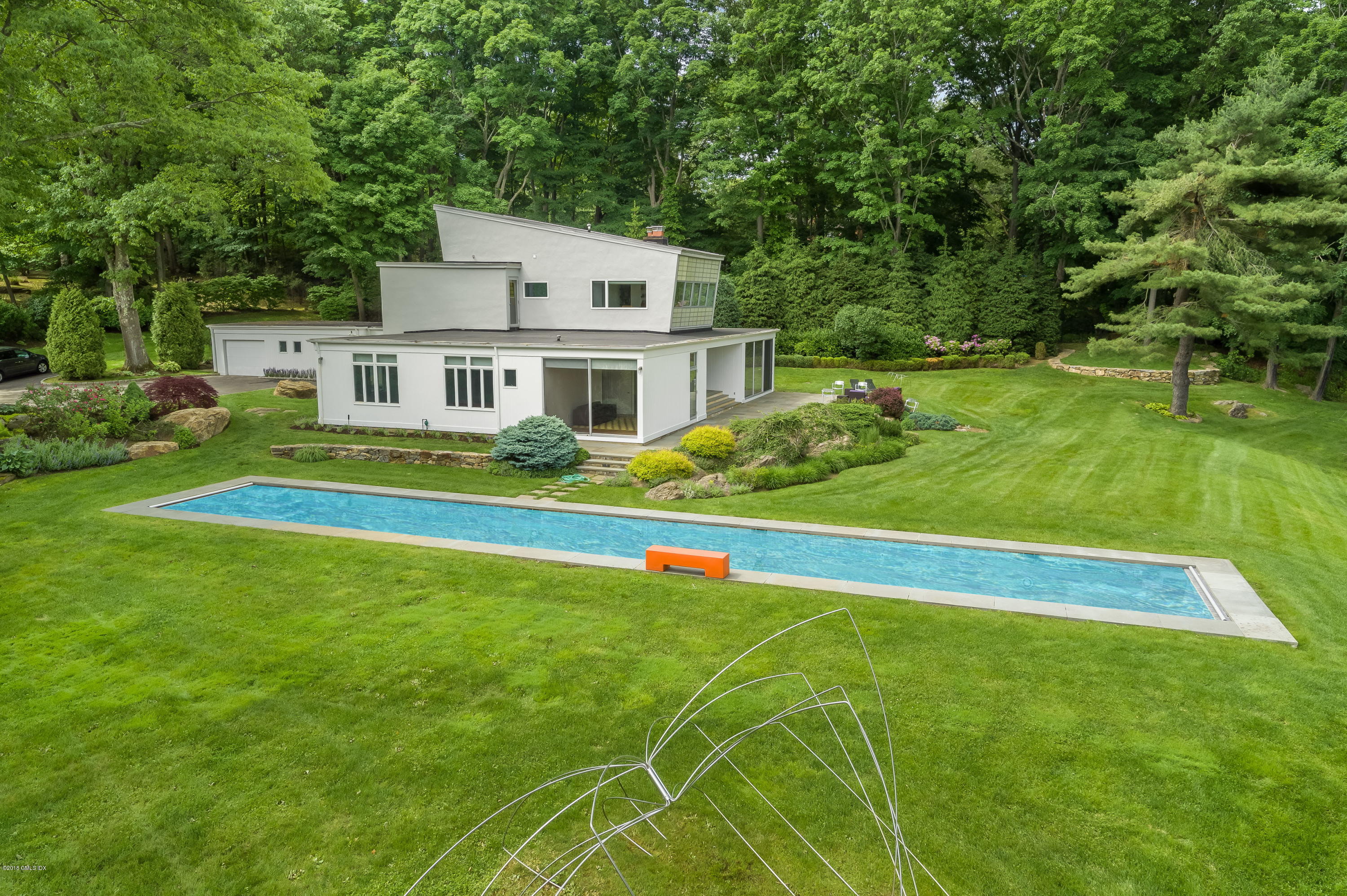 491 Riversville Road Greenwich, CT 06831 - Photo 27 of 30 a house with green field in front of it