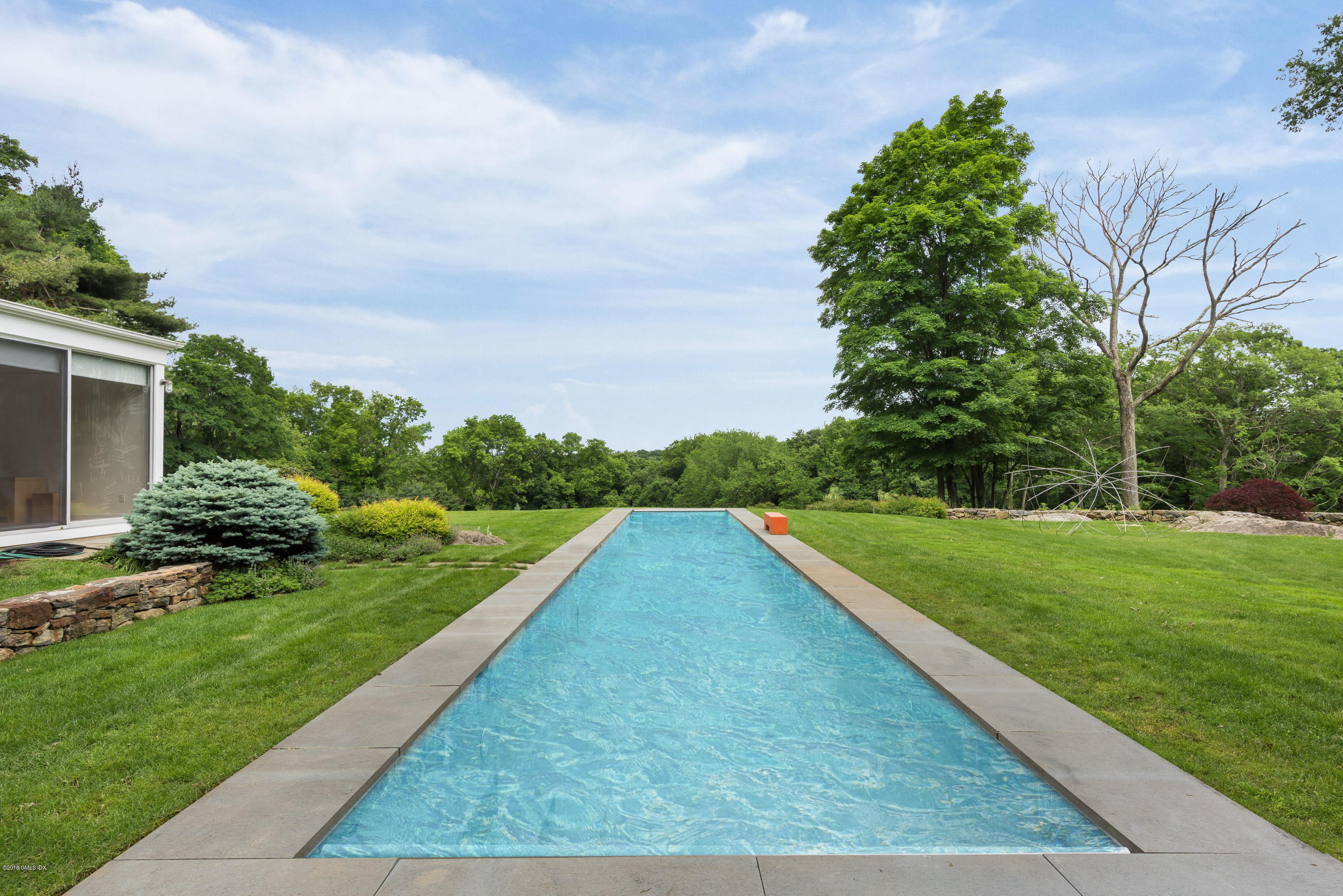 491 Riversville Road Greenwich, CT 06831 - Photo 3 of 30 a view of a backyard with plants and a garden