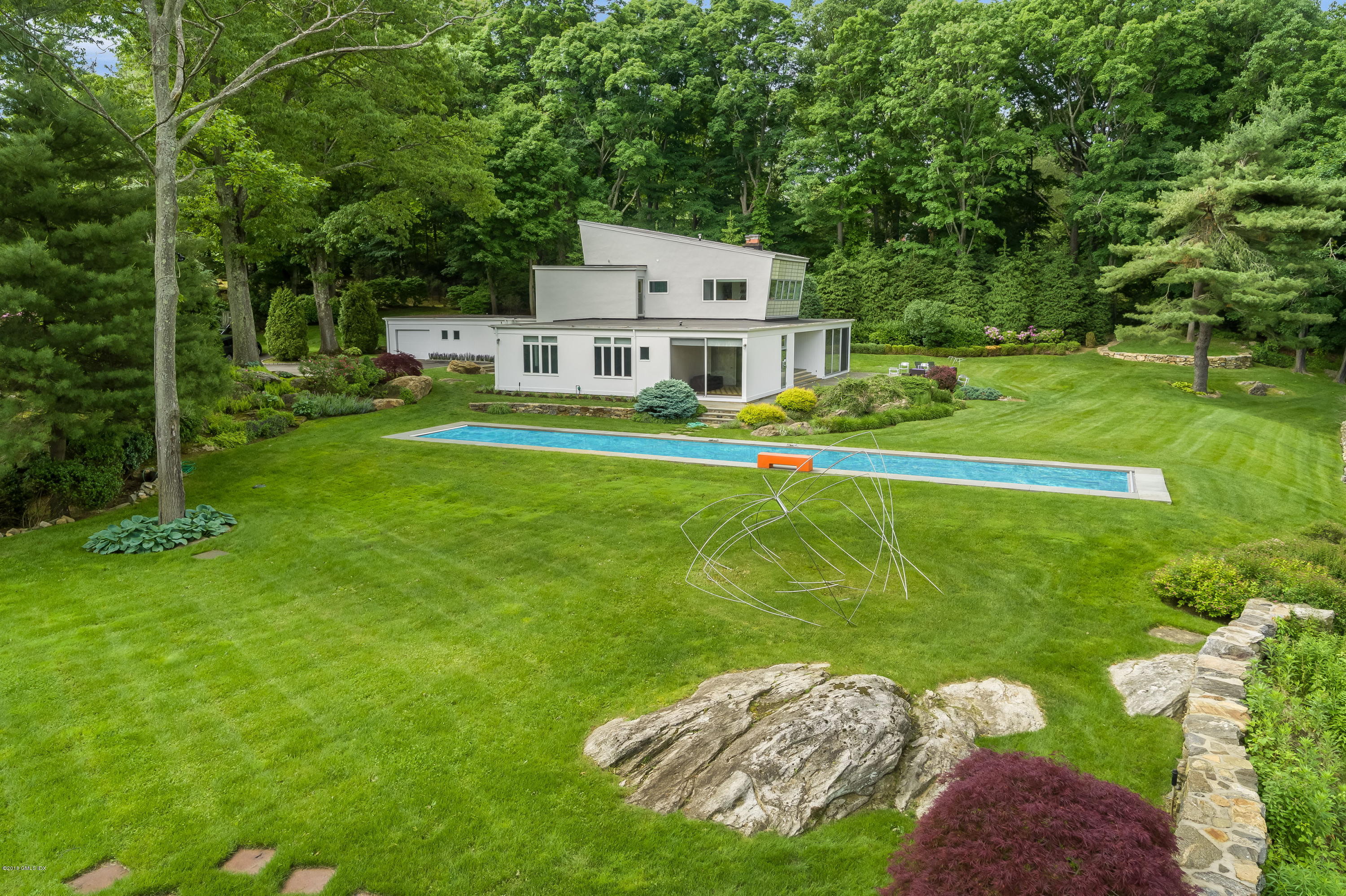 491 Riversville Road Greenwich, CT 06831 - Photo 4 of 30 a aerial view of a house with a big yard and large trees