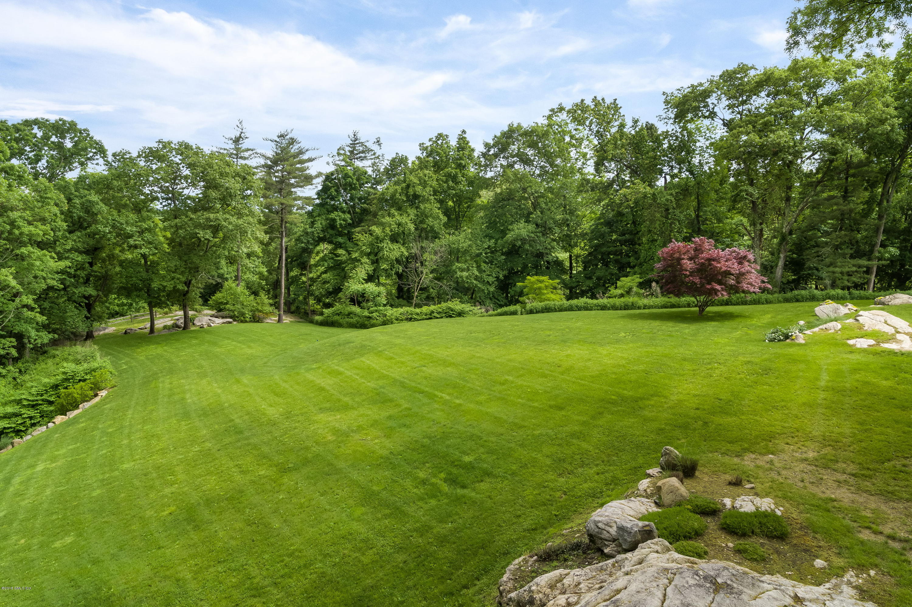491 Riversville Road Greenwich, CT 06831 - Photo 7 of 30 a backyard of a house with lots of green space and garden