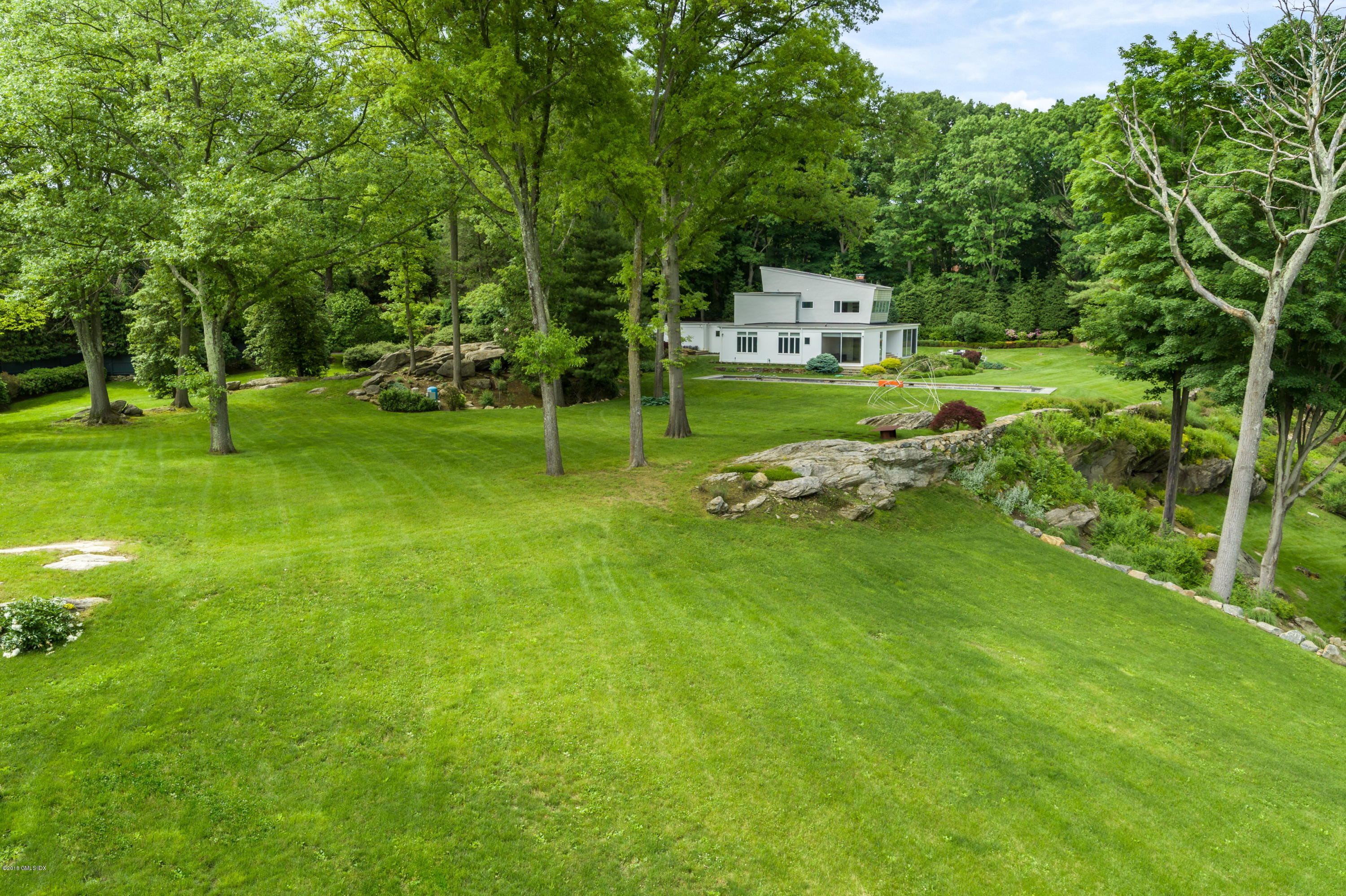 491 Riversville Road Greenwich, CT 06831 - Photo 8 of 30 a green field with lots of trees in it