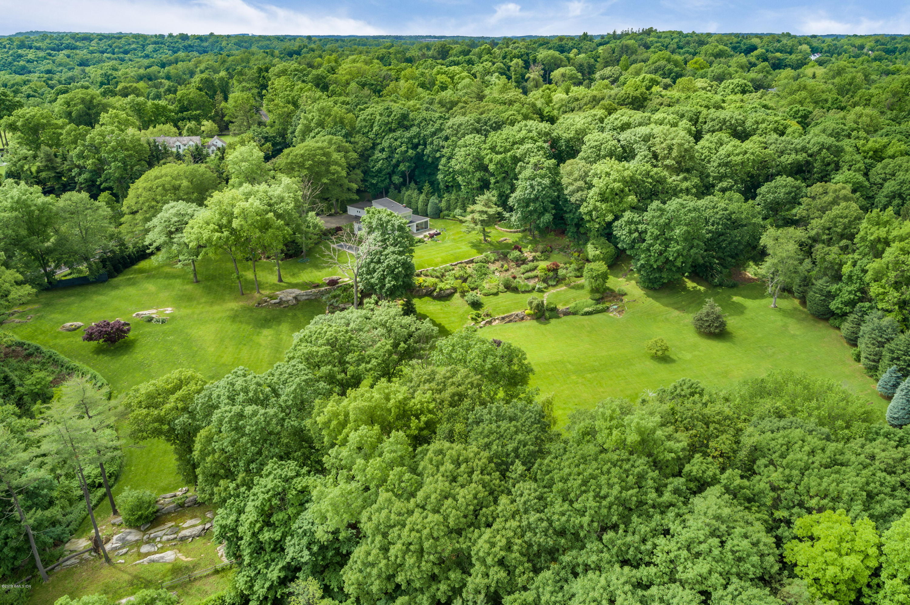 491 Riversville Road Greenwich, CT 06831 - Photo 10 of 30 a view of a big yard with large trees and plants