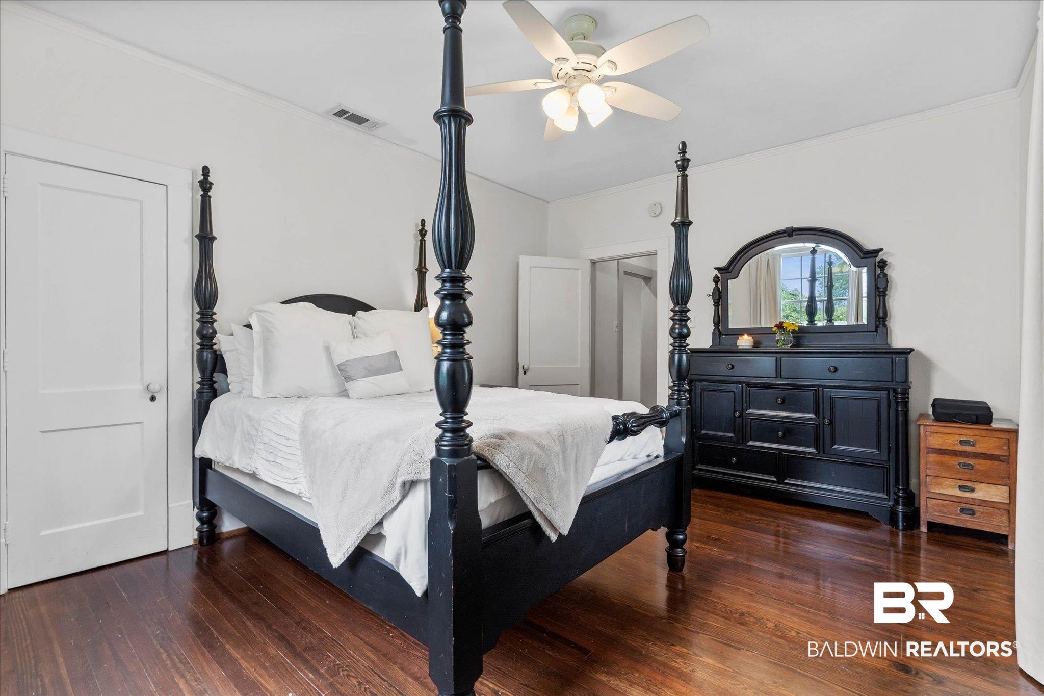 3863 Old Shell Road Mobile, AL 36608 - Photo 31 of 48 Spacious room featuring rich wood-finish flooring, a ceiling fan with integrated lighting, and multiple white paneled doors