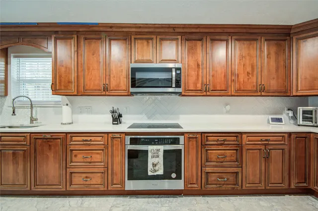 a kitchen with stainless steel appliances granite countertop a sink and cabinets