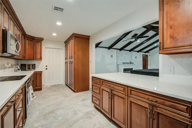 a kitchen with stainless steel appliances granite countertop a sink and cabinets