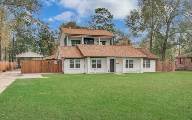 a view of a house with a yard and sitting area