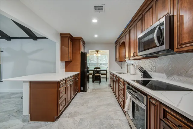 a kitchen with stainless steel appliances a sink and a stove