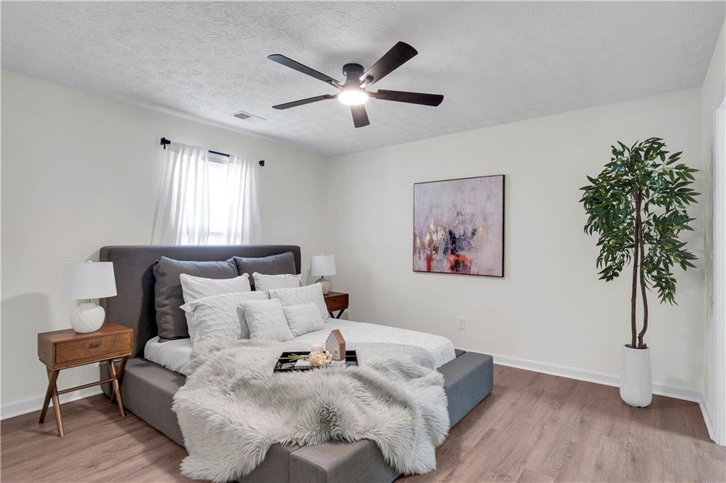 592 Linda Lane Powder Springs, GA 30127 - Photo 13 of 21 a bed room with a bed and a chandelier