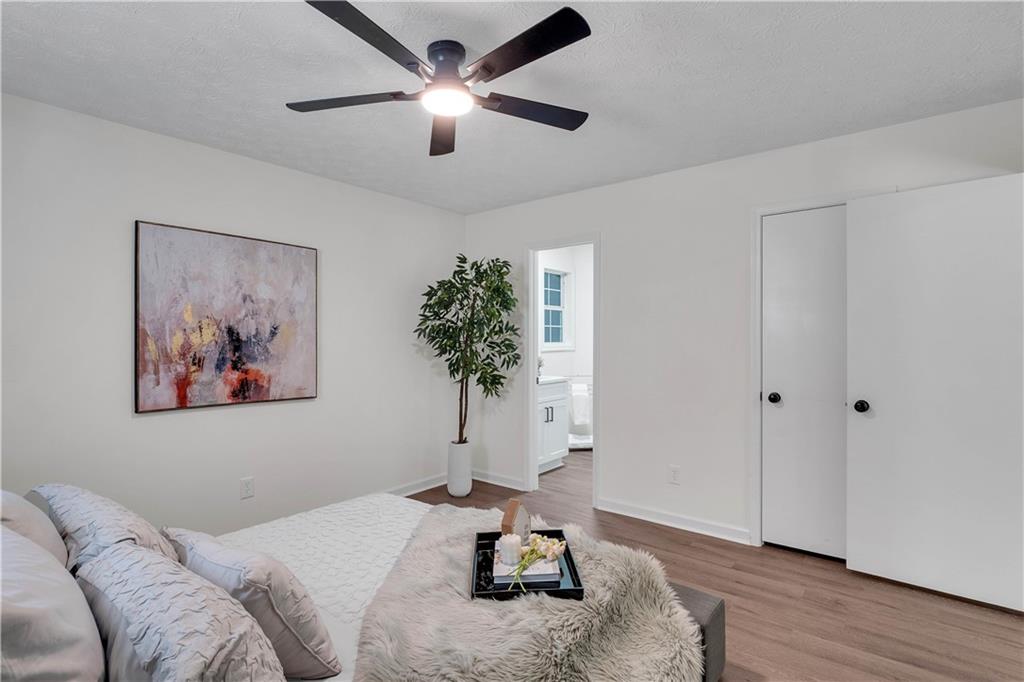 592 Linda Lane Powder Springs, GA 30127 - Photo 14 of 21 a bedroom with a bed and a chandelier