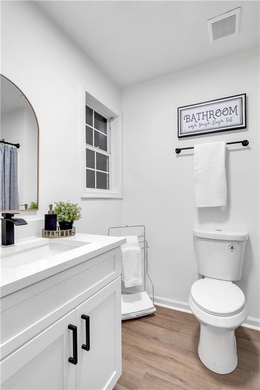 592 Linda Lane Powder Springs, GA 30127 - Photo 15 of 21 a bathroom with a toilet a sink and mirror