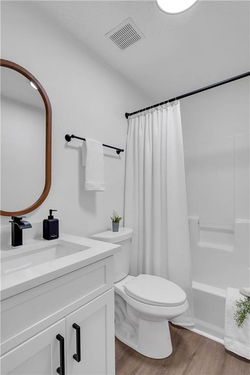 592 Linda Lane Powder Springs, GA 30127 - Photo 17 of 21 a bathroom with a toilet sink a mirror a vanity and shower