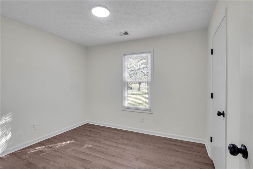 592 Linda Lane Powder Springs, GA 30127 - Photo 18 of 21 an empty room with wooden floor and windows