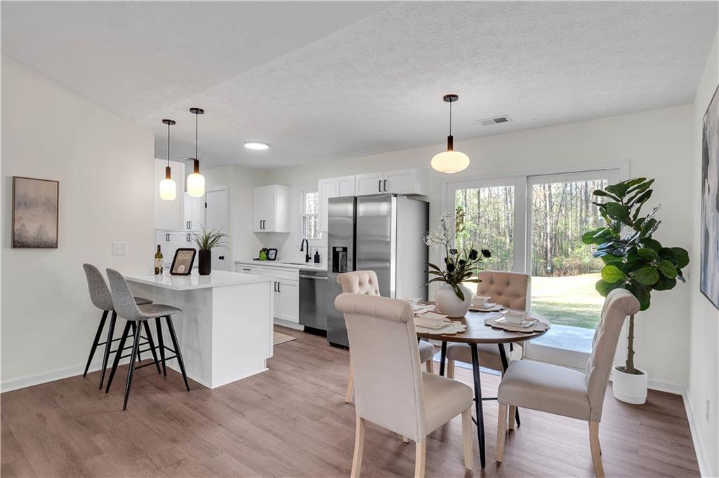 592 Linda Lane Powder Springs, GA 30127 - Photo 8 of 21 a view of a dining room with furniture window and wooden floor