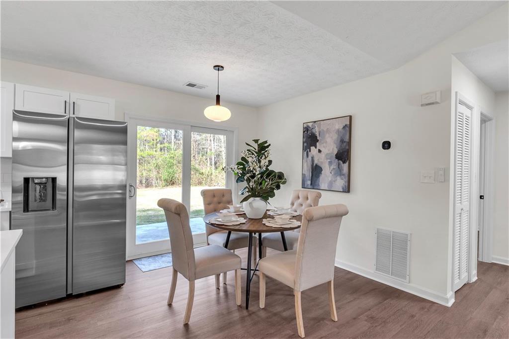 592 Linda Lane Powder Springs, GA 30127 - Photo 9 of 21 a dining room with furniture and wooden floor