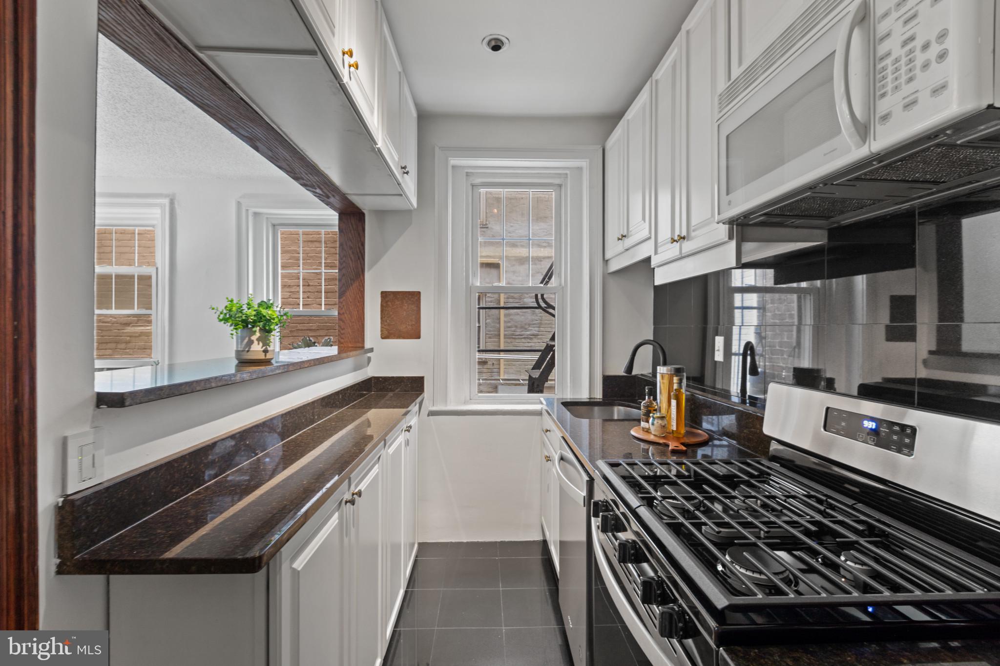 1332 15th Street Northwest, Unit 2 Washington, DC 20005 - Photo 11 of 28 a kitchen with stainless steel appliances granite countertop a stove and a sink