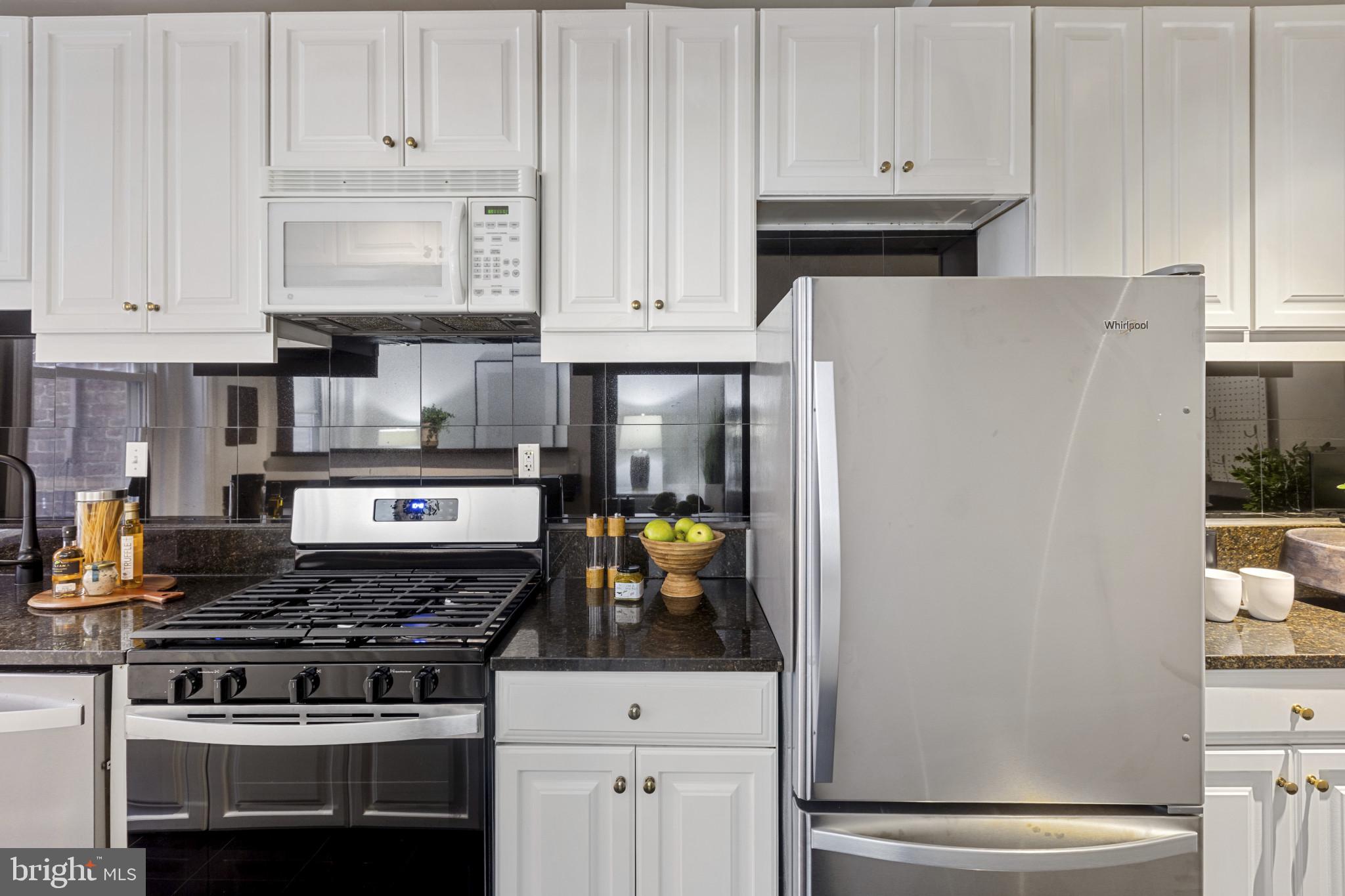 1332 15th Street Northwest, Unit 2 Washington, DC 20005 - Photo 12 of 28 a kitchen with stainless steel appliances granite countertop a refrigerator and a stove