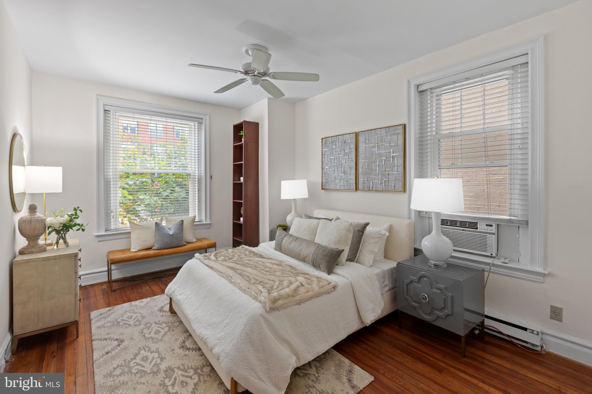 1332 15th Street Northwest, Unit 2 Washington, DC 20005 - Photo 19 of 28 a bedroom with a bed wooden floor and window