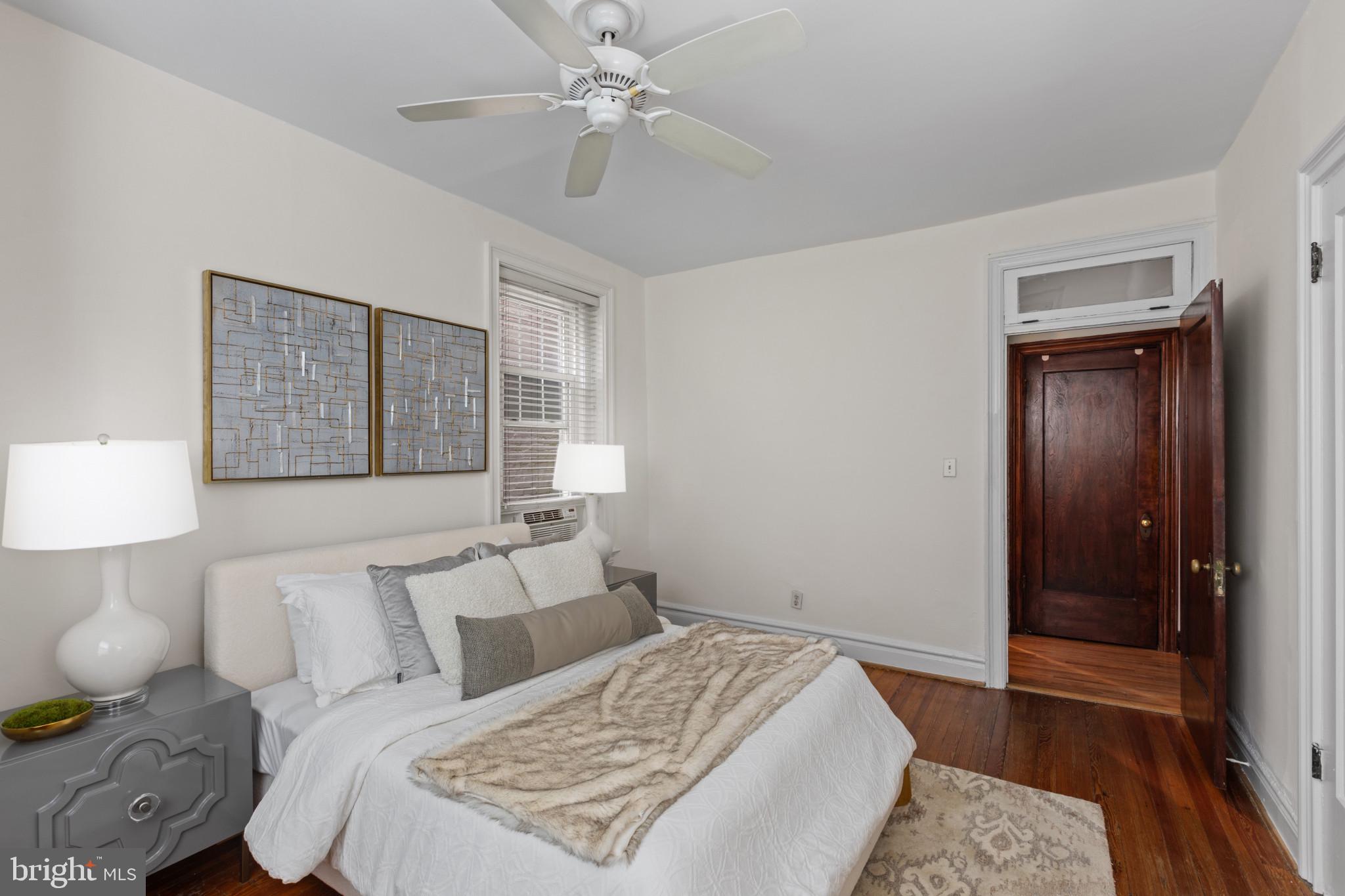 1332 15th Street Northwest, Unit 2 Washington, DC 20005 - Photo 21 of 28 a bedroom with a large bed and a chandelier