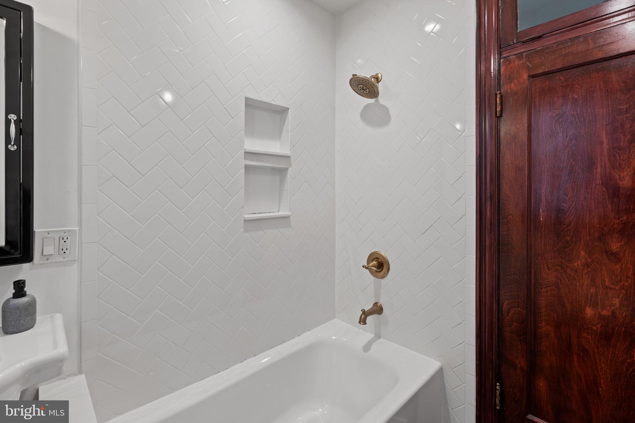 1332 15th Street Northwest, Unit 2 Washington, DC 20005 - Photo 23 of 28 a bathroom with a white bath tub and a sink