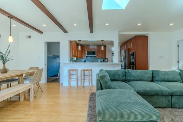 a living room with furniture and kitchen view
