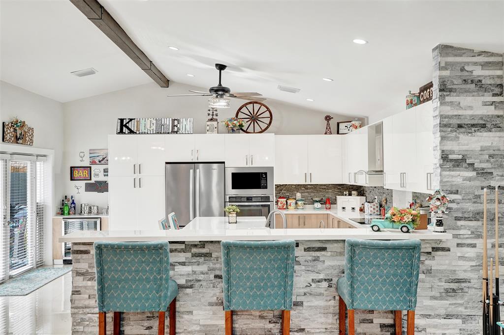 5076 Northwest 84th Road Coral Springs, FL 33067 - Photo 15 of 74 a kitchen with stainless steel appliances granite countertop a stove a sink and a refrigerator