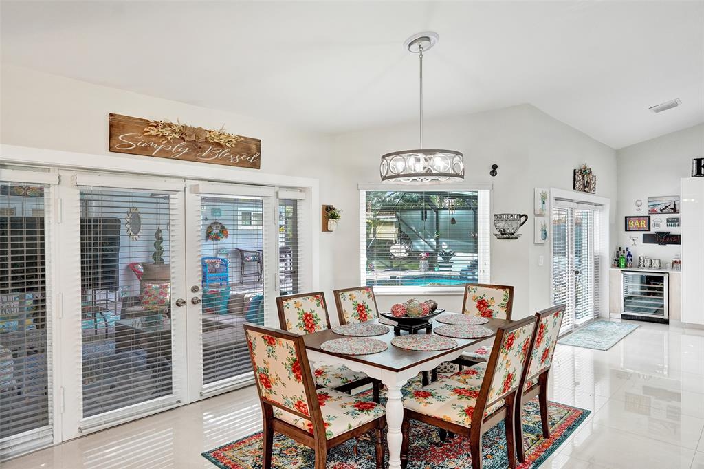 5076 Northwest 84th Road Coral Springs, FL 33067 - Photo 18 of 74 a view of a dining room with furniture window and wooden floor