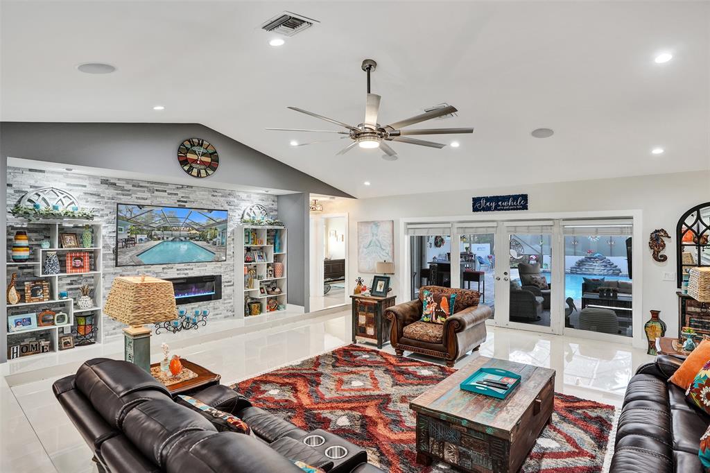 5076 Northwest 84th Road Coral Springs, FL 33067 - Photo 3 of 74 a living room with furniture kitchen view and a large window