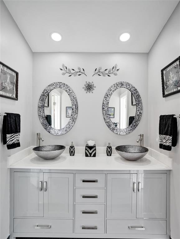 5076 Northwest 84th Road Coral Springs, FL 33067 - Photo 32 of 74 a bathroom with a double vanity sink and a mirror
