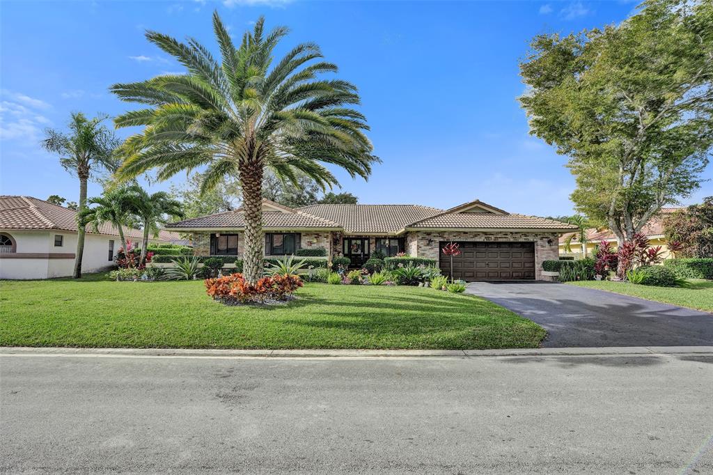5076 Northwest 84th Road Coral Springs, FL 33067 - Photo 63 of 74 a front view of house with yard and green space