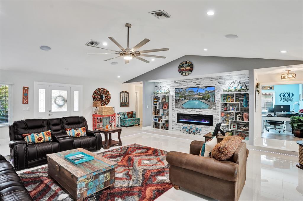 5076 Northwest 84th Road Coral Springs, FL 33067 - Photo 7 of 74 a living room with furniture a flat screen tv and a window