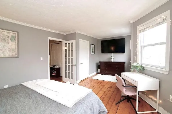 a bedroom with a bed and a flat screen tv