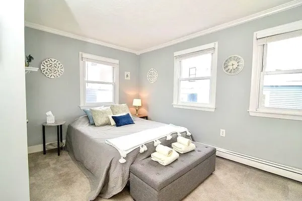 a bedroom with a bed and a window