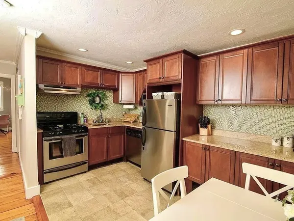 a kitchen with a sink a refrigerator and cabinets
