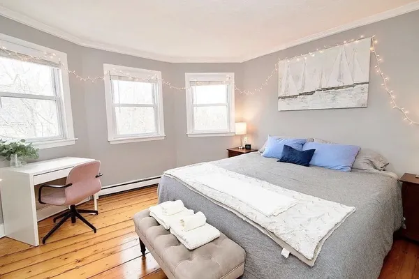 a bedroom with a bed a table and chair