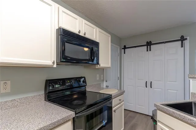 a kitchen with stainless steel appliances a stove a microwave and cabinets