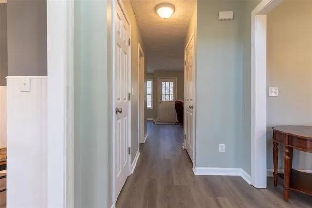 a view of a hallway with wooden floor