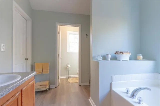 a en suite bathroom with a sink and a tub