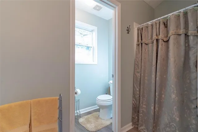a bathroom with a toilet and a shower