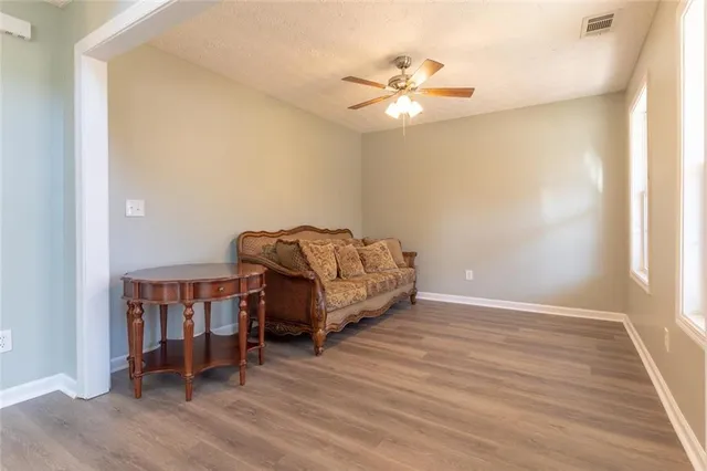 a living room with furniture and a wooden floor
