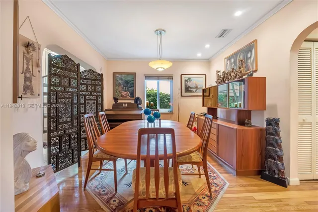 a kitchen with stainless steel appliances granite countertop a stove a sink and white cabinets
