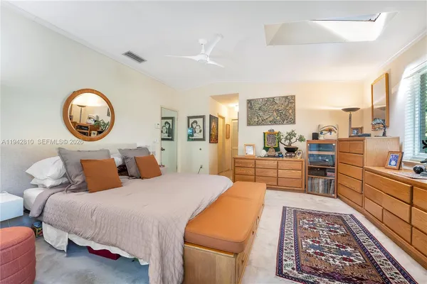 a spacious bedroom with a bed and wooden floor