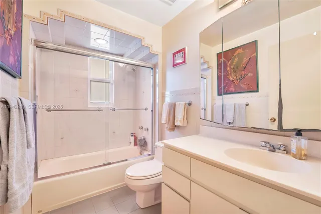 a bedroom with bed and a view of living room