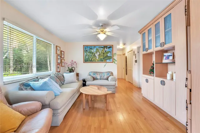 a living room with furniture and a floor to ceiling window