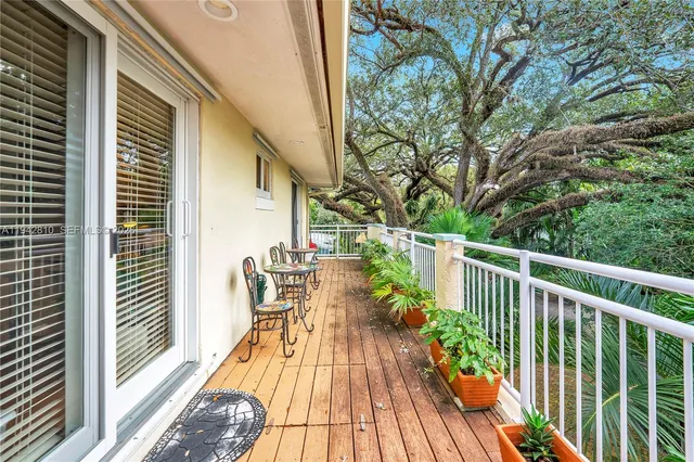 a balcony with chairs and wooden floor