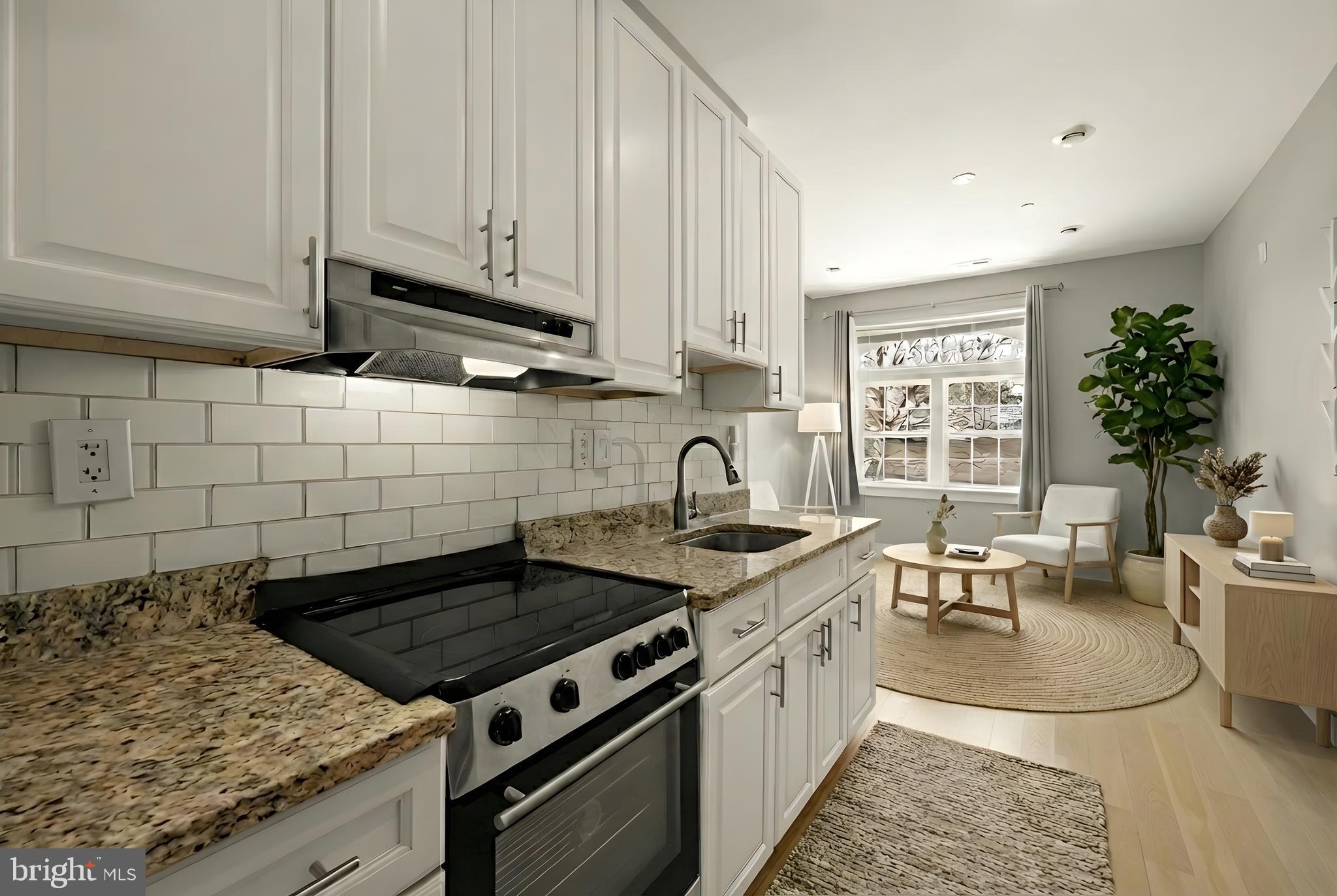 3529 14th Street Northwest, Unit 1 Washington, DC 20010 - Photo 4 of 14 a kitchen with granite countertop a stove a sink dishwasher and cabinets