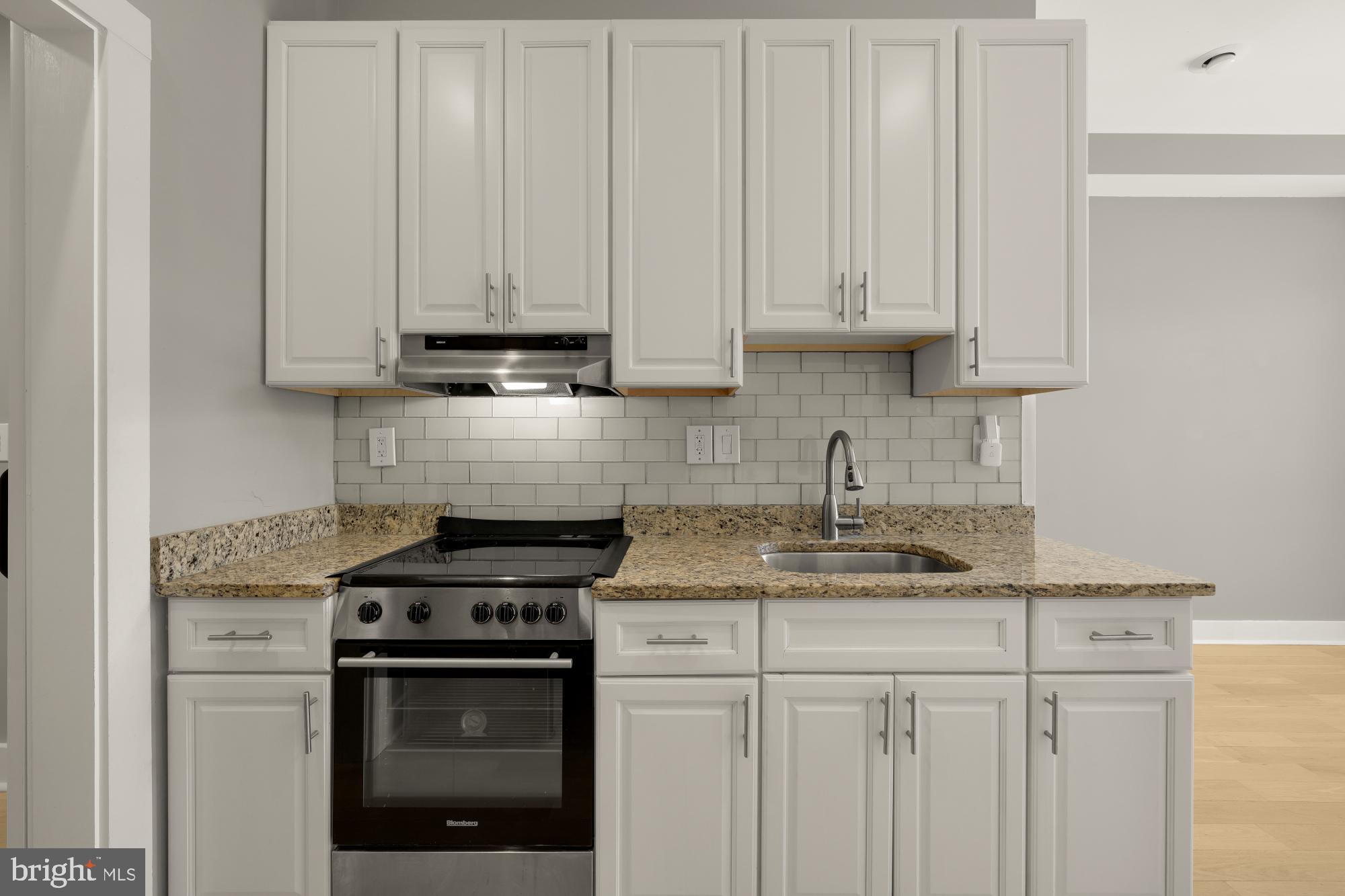 3529 14th Street Northwest, Unit 1 Washington, DC 20010 - Photo 5 of 14 a kitchen with stainless steel appliances granite countertop white cabinets sink and dishwasher
