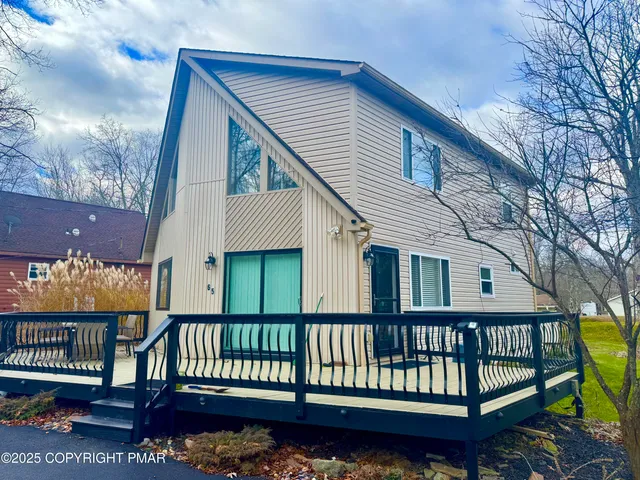 a house that has a tree in front of the house