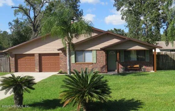 a front view of house with yard and green space