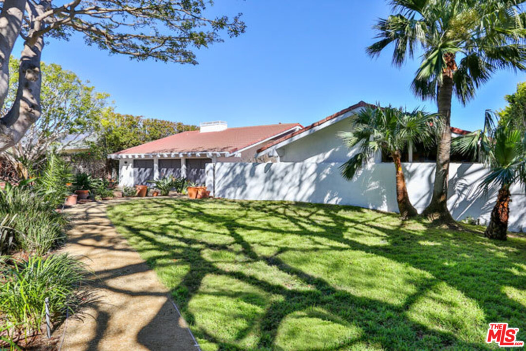 7050 Dume Drive Malibu, CA 90265 - Photo 4 of 13 a view of a swimming pool with a garden